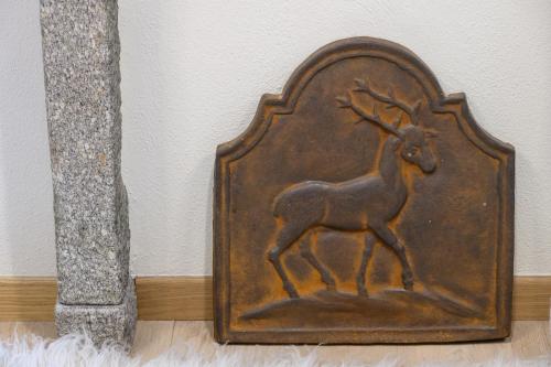a metal picture of a deer on a wall at "Vue Du Clocher" - Etroubles Boutique Apartment in Etroubles