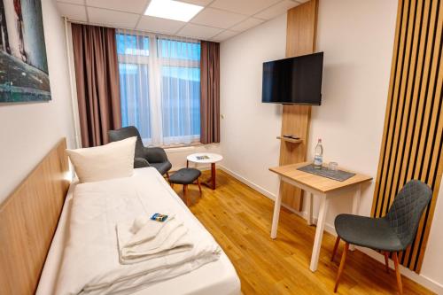a hospital room with a bed and a tv at Sonnenschein Hotel & Apartments in Heilbad Heiligenstadt