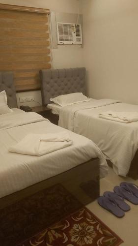 a room with two beds and a window at Hotel Hangout in Jangipur