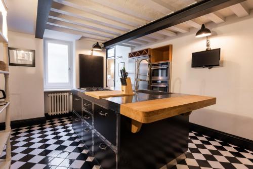 a kitchen with a black and white checkered floor at Rinascimento Privato by MMega in Florence