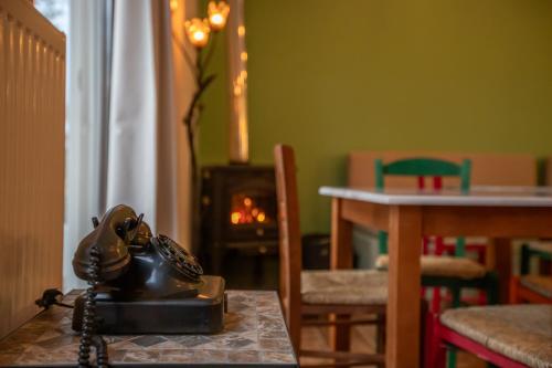 a telephone sitting on a table in a room with a fireplace at Ξαπόσταμα XAPOSTAMA - Ενοικιαζόμενα Δωμάτια in Kalyvia