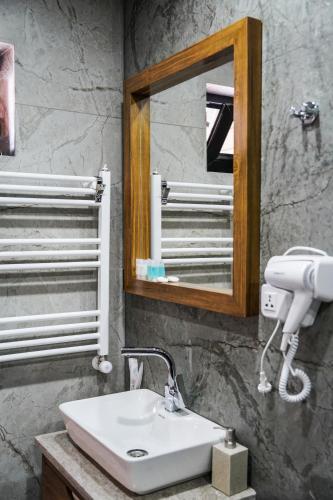 a bathroom with a sink and a mirror at Cottage River Sound in Kazbegi