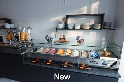 a kitchen with a counter with some food on it at Pensiunea Warthe Bed & Breakfast in Braşov