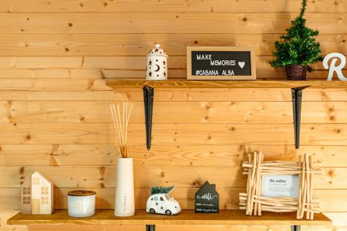 a shelf in a wooden wall with items on it at Apusenity- Refugiu modern în inima naturii, aproape de Cluj in Cluj-Napoca