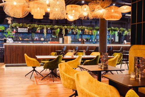 a restaurant with tables and chairs and chandeliers at Rioca Konstanz Posto 10 in Konstanz