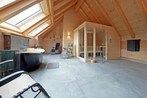 a large room with a vaulted ceiling with a window at Haldenhof, Design Retreat im Schwarzwald by living TIMELESS in Simonswald