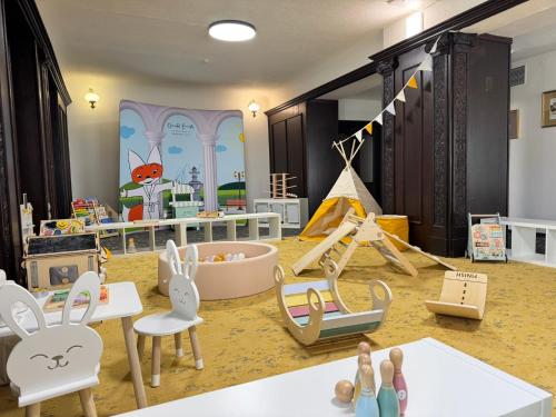 a childs play room with chairs and toys in it at OREA Spa Hotel Palace Zvon Mariánské Lázně in Mariánské Lázně