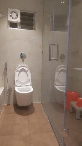 a bathroom with a toilet and two urinals in it at Hotel Hangout in Jangipur