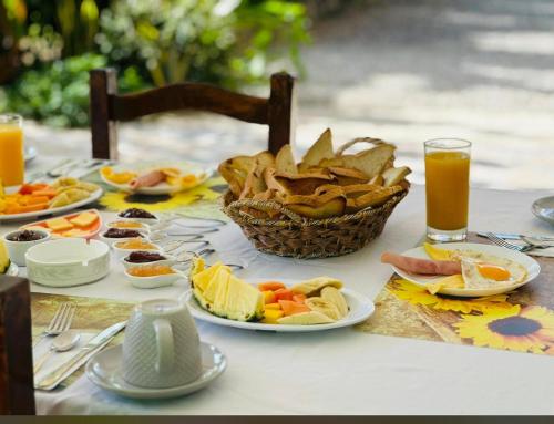 a table with plates of food and a basket of chips at Casa Mariana in Las Terrenas