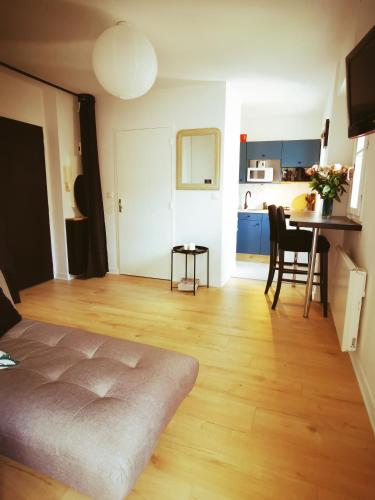 Cette chambre comprend un lit, une table et une cuisine. dans l'établissement Studio bas Sablon - 50m plage, à Saint-Malo