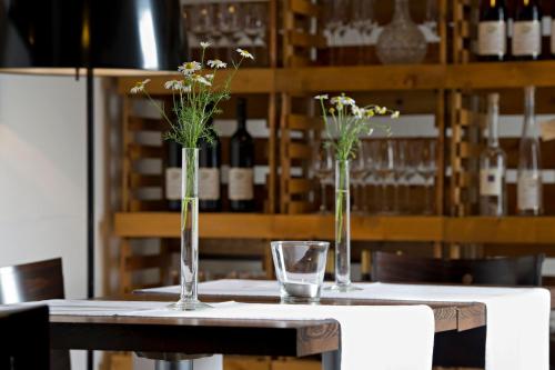 two vases with flowers in them sitting on a table at Burgblickhotel in Bernkastel-Kues