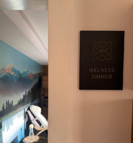 a door with a sign that reads wellness zimmer at Berg-Bijou Scuol in Scuol