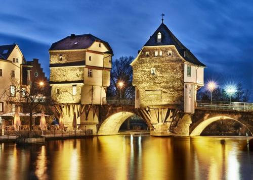 a bridge over a river with a building on it at Ferienhaus Auszeit in Bad Kreuznach