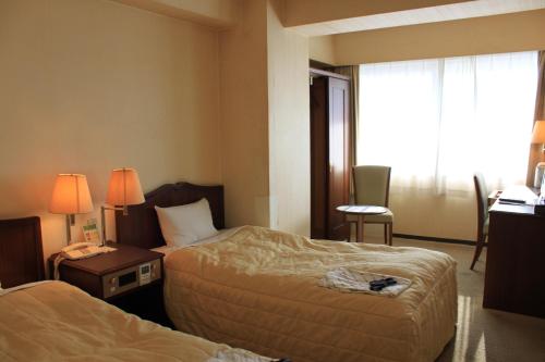 Ένα ή περισσότερα κρεβάτια σε δωμάτιο στο Ichihara Marine Hotel