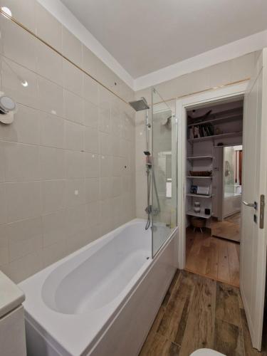 a white bath tub in a bathroom with a toilet at Frascati center modern home in Frascati