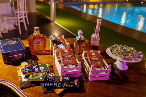 a table with snacks and drinks on it next to a pool at Hotel I Gigli in Nola