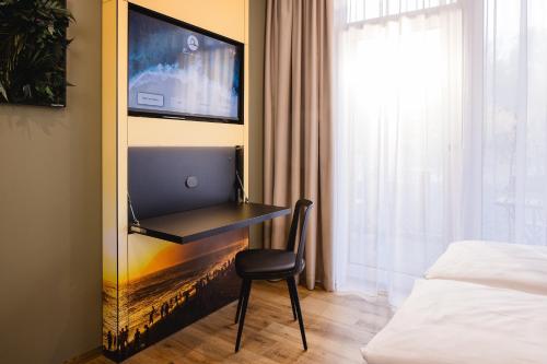a bedroom with a desk with a laptop on it at Rioca Konstanz Posto 10 in Konstanz
