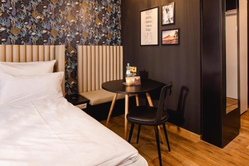 a bedroom with a bed and a table with a cake at Rioca Konstanz Posto 10 in Konstanz
