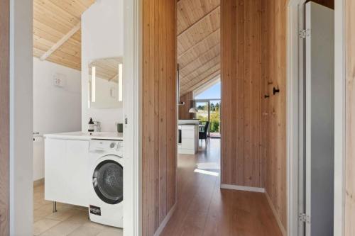 a laundry room with a washer and dryer in a house at Lovely Summer House With Spa, Close To The Beach in Vejby