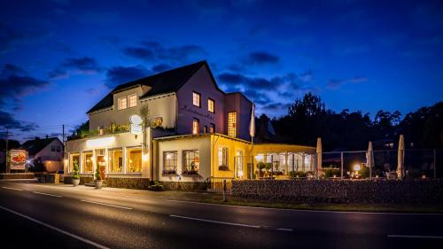 a large house on the side of a road at night at Hotel Kalenborner Höhe in Kalenborn