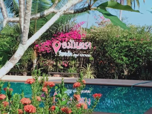 a sign for a flower garden at the dubai miracle garden at Amantra Resort Satun in Ban Prok To Lem