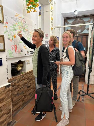 a group of women standing in a room pointing to a wall at Friends Hotel & Rooftop - Historic Center & Museums in Quito