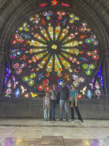 a group of people standing in front of a stained glass window at Friends Hotel & Rooftop - Historic Center & Museums in Quito
