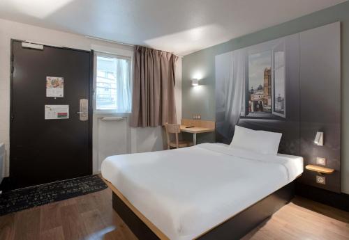 Ένα ή περισσότερα κρεβάτια σε δωμάτιο στο B&B HOTEL Louveciennes