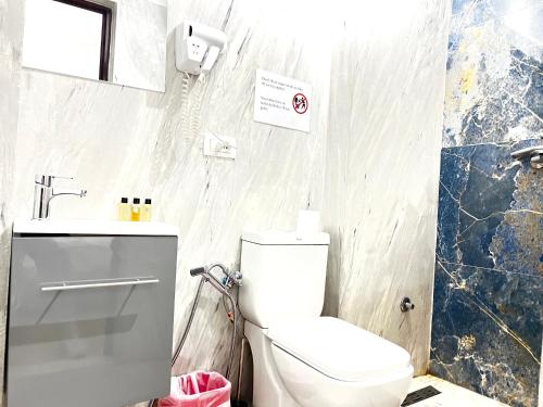 a bathroom with a toilet and a sink at Tirana Square Hotel in Tirana