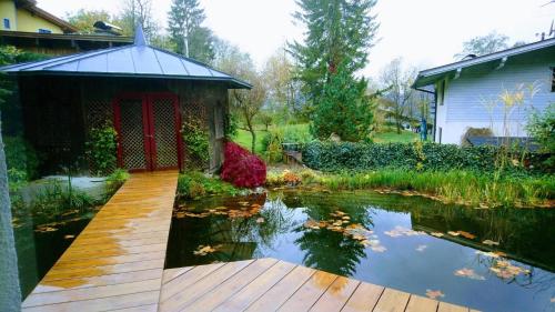 a pond with a gazebo next to a house at Kaiserhaus Harald Astner Ebbs Studio 1 in Ebbs