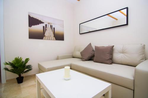 a living room with a couch and a table at Apartamentos Centro Puerto de Santa Maria in El Puerto de Santa María