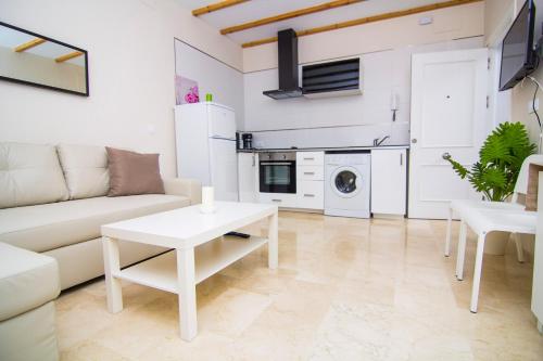 a living room with a couch and a table at Apartamentos Centro Puerto de Santa Maria in El Puerto de Santa María