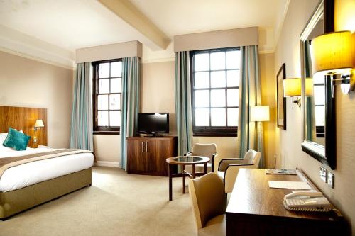 a hotel room with a bed and a desk at The Grand, York in York