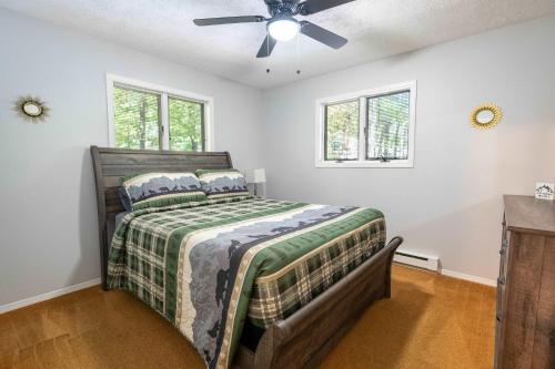 a bedroom with a bed and a ceiling fan at Home Tucked into Towamensing Trails in Albrightsville