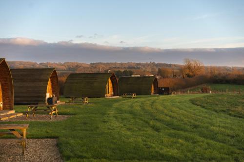 a group of huts on a grassy field at Millside by Wigwam Holidays in Grantham