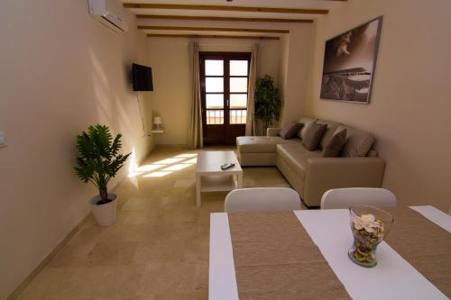 a living room with a couch and a table at Apartamentos Centro Puerto de Santa Maria in El Puerto de Santa María