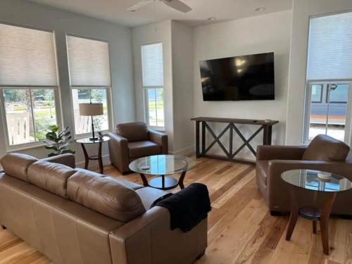 a living room with a couch and a table at Gator Grove - Queen Ann White - New Build! in Gainesville