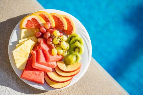 a plate of fruit on top of a table at Nereides Hotel in Karpathos Town