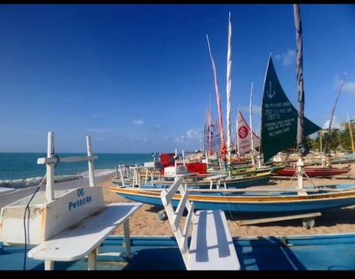 a group of boats parked on the beach at Pousada Deus Provera in Maceió