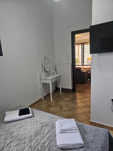 a bedroom with a bed and a mirror and a sink at STUDIO Θαλλώ Thallo in Galaxidhion
