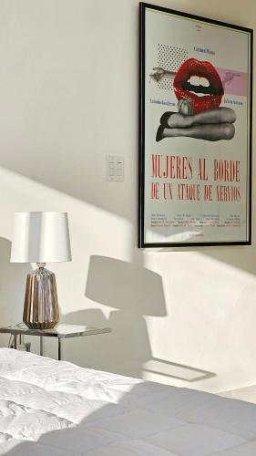 a poster on a wall in a bedroom with a bed at Casa Reina by Villa Alejandro in Boquete