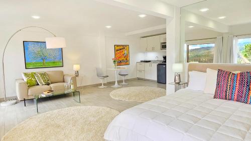 a bedroom with a white bed and a living room at Casa Reina by Villa Alejandro in Boquete