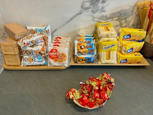 two trays filled with food and a bowl of candy at Cristina's House in Ferrara
