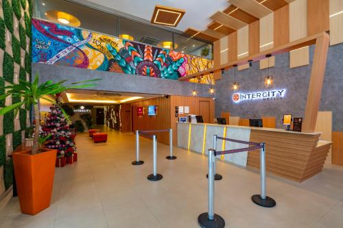 a hospital lobby with a christmas tree in the center at Intercity Salvador in Salvador