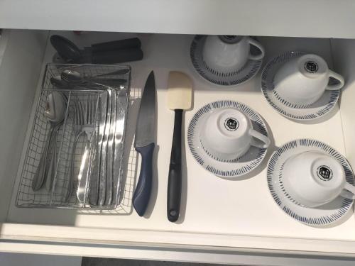 a drawer with plates and utensils in a kitchen at Relax MDZ - Memorable Apt in Godoy Cruz
