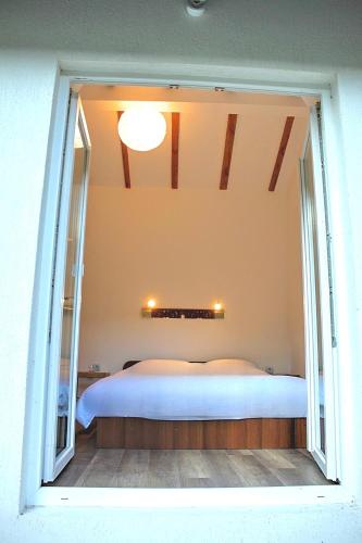 a bedroom with a large bed with a large window at Пе́трови Вили in Ribarica
