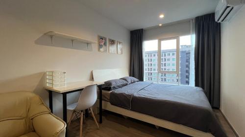 a bedroom with a bed and a desk and a window at GM bangson home in Bangkok