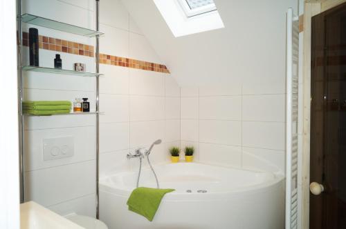 a bathroom with a tub and a sink at Premium Apartments in Wendisch Rietz