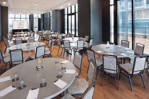 a conference room with tables and chairs in a building at Hôtel AC Montréal Centre-ville in Montréal