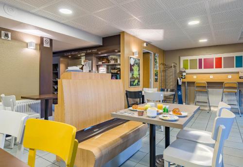 une salle à manger avec une table et des chaises dans l'établissement B&B HOTEL Tours Nord 1 Val de Loire, à Tours